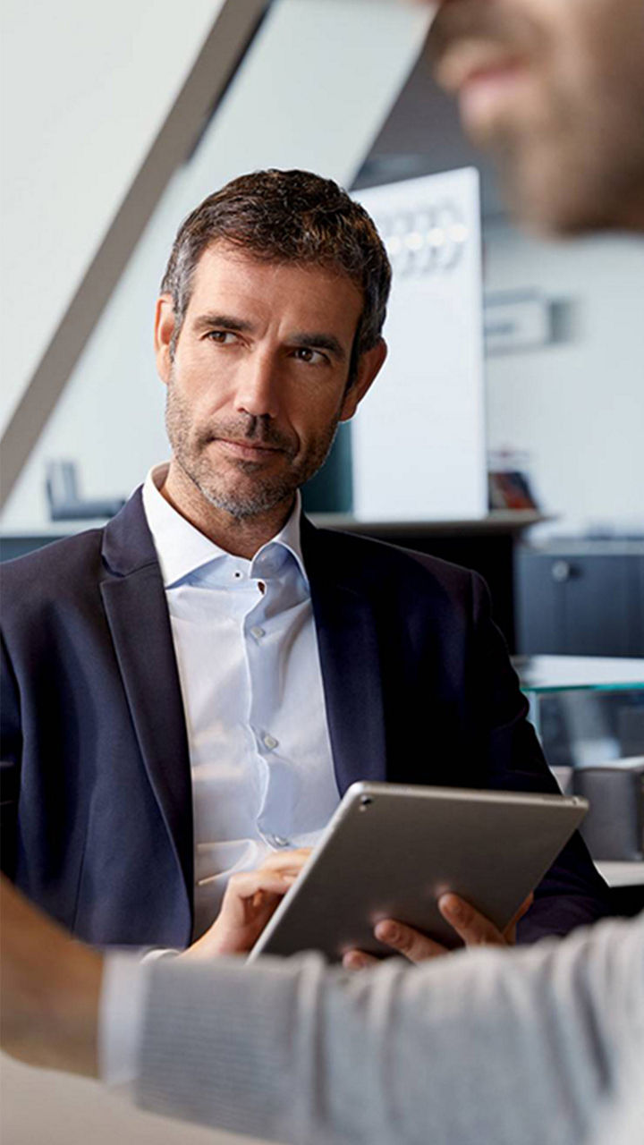 Audi finance manager taking notes.