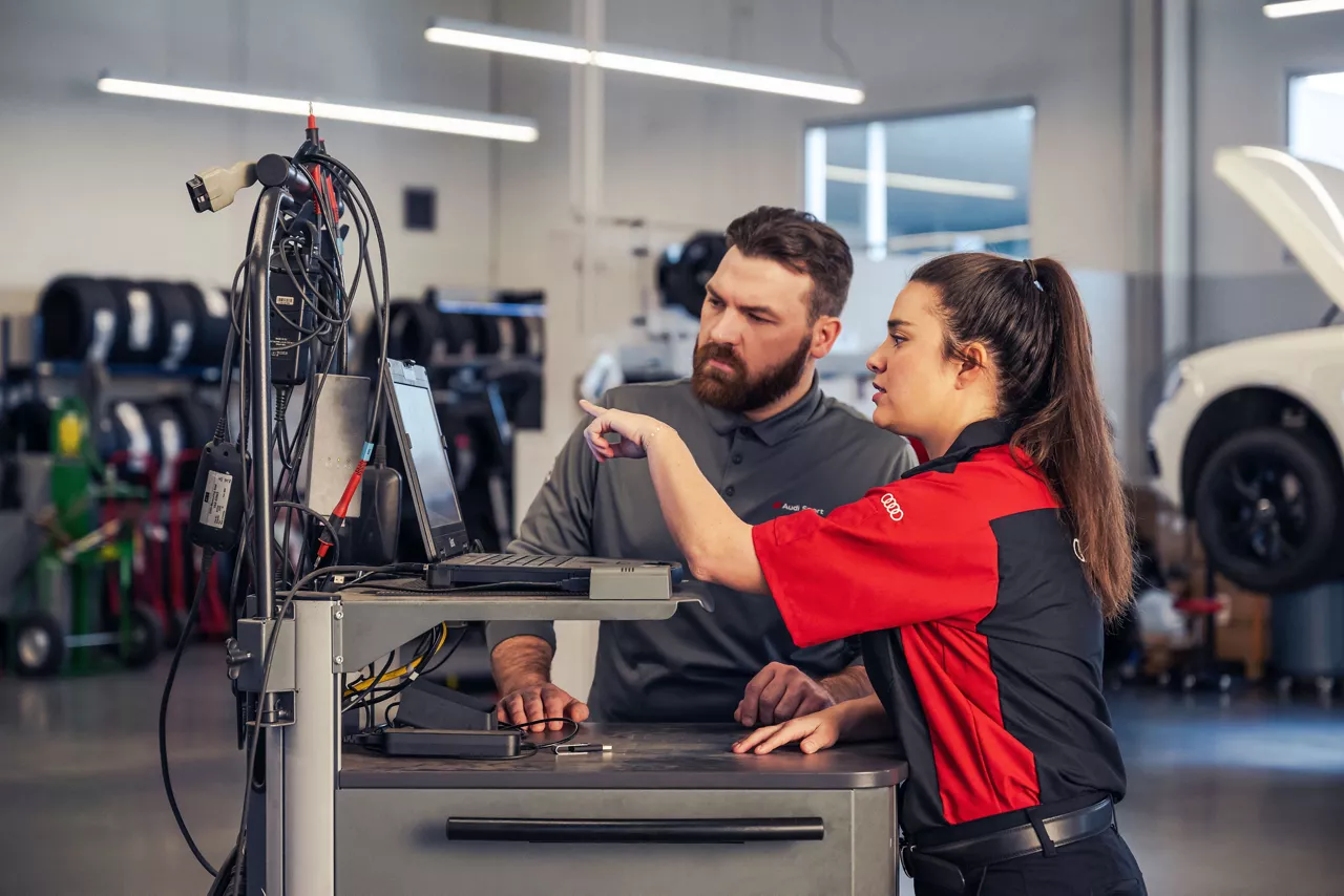Service technicians reviewing information on a computer.