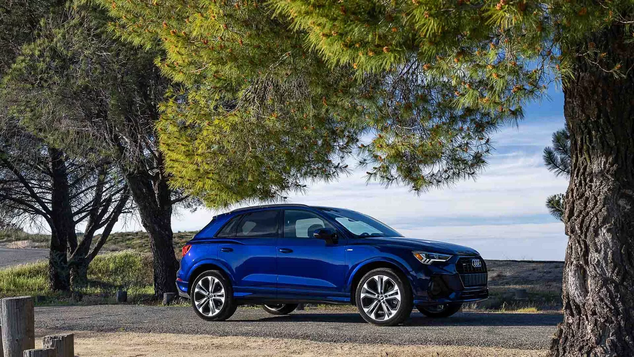 Side profile view of an Audi vehicle parked.