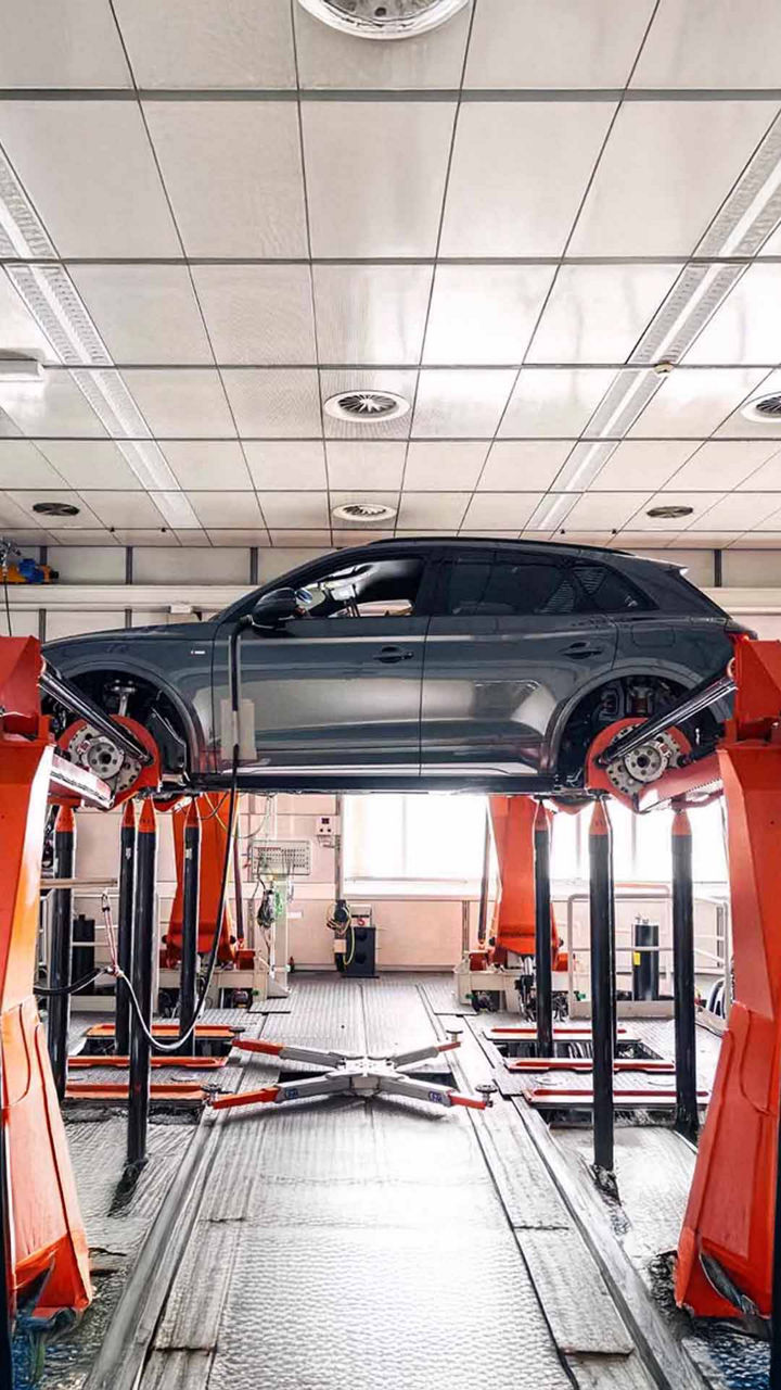 Front profile view of an Audi Q5 vehicle being serviced.