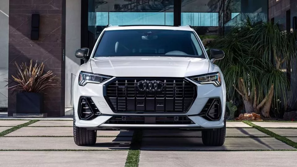 2025 Audi Q3 exterior design in front of Audi Oakville dealership, showcasing bold grille and LED headlights