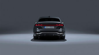 Rear view of a 2025 Audi A5 model with rear headlights on.