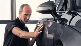 Service technician servicing vehicle.
