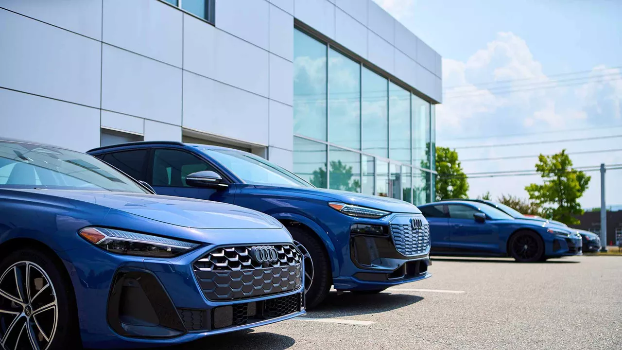 Audi vehicles parked outside of the dealership.