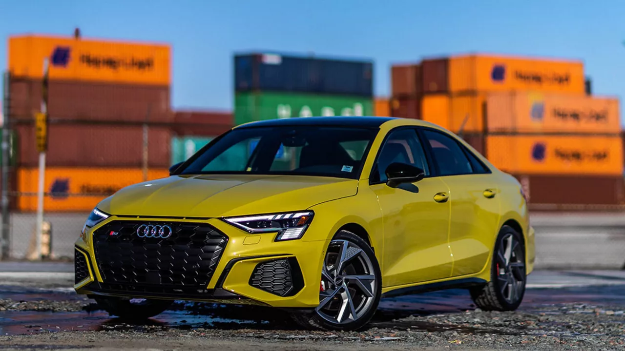 Audi employee handing a set of car keys to a customer.