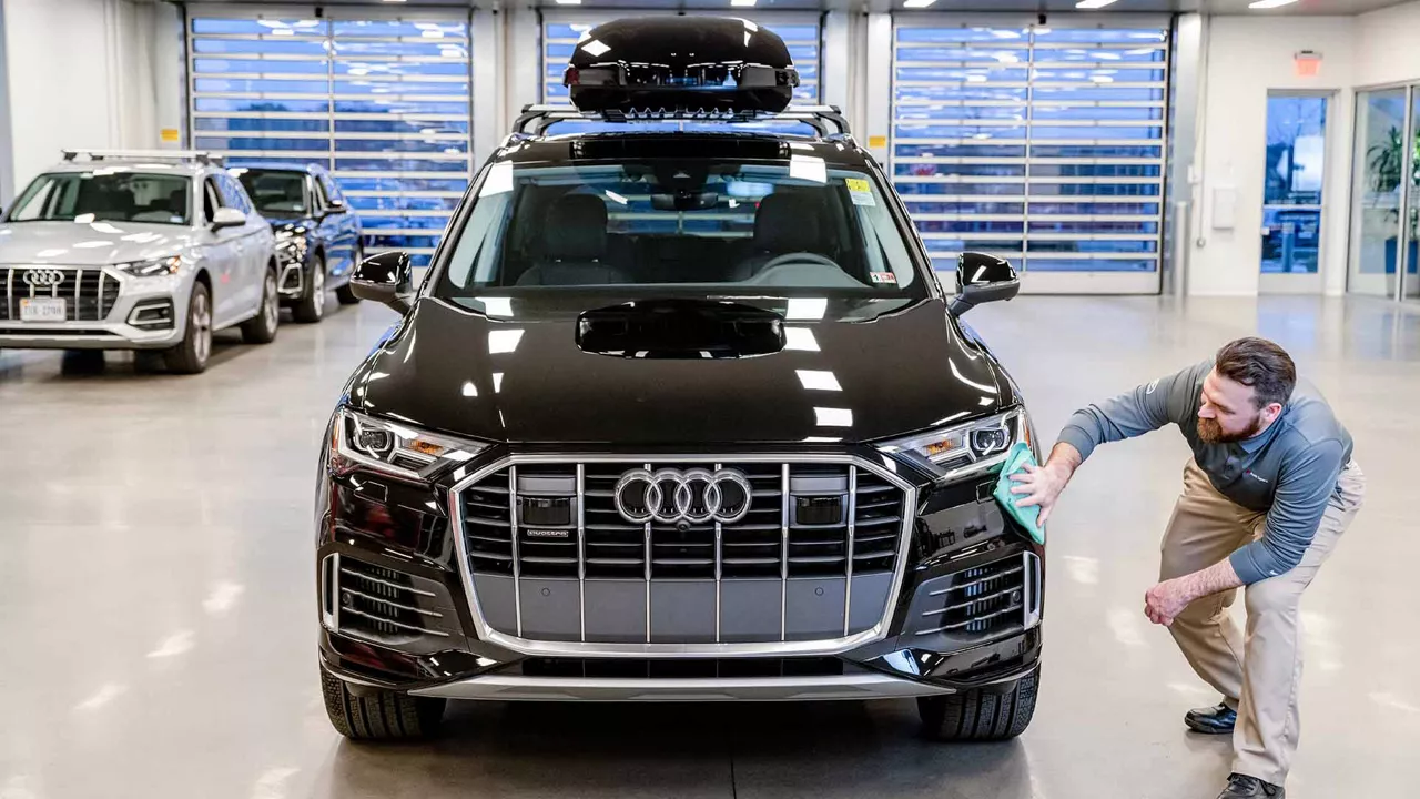 Audi employee polishing an Audi SUV