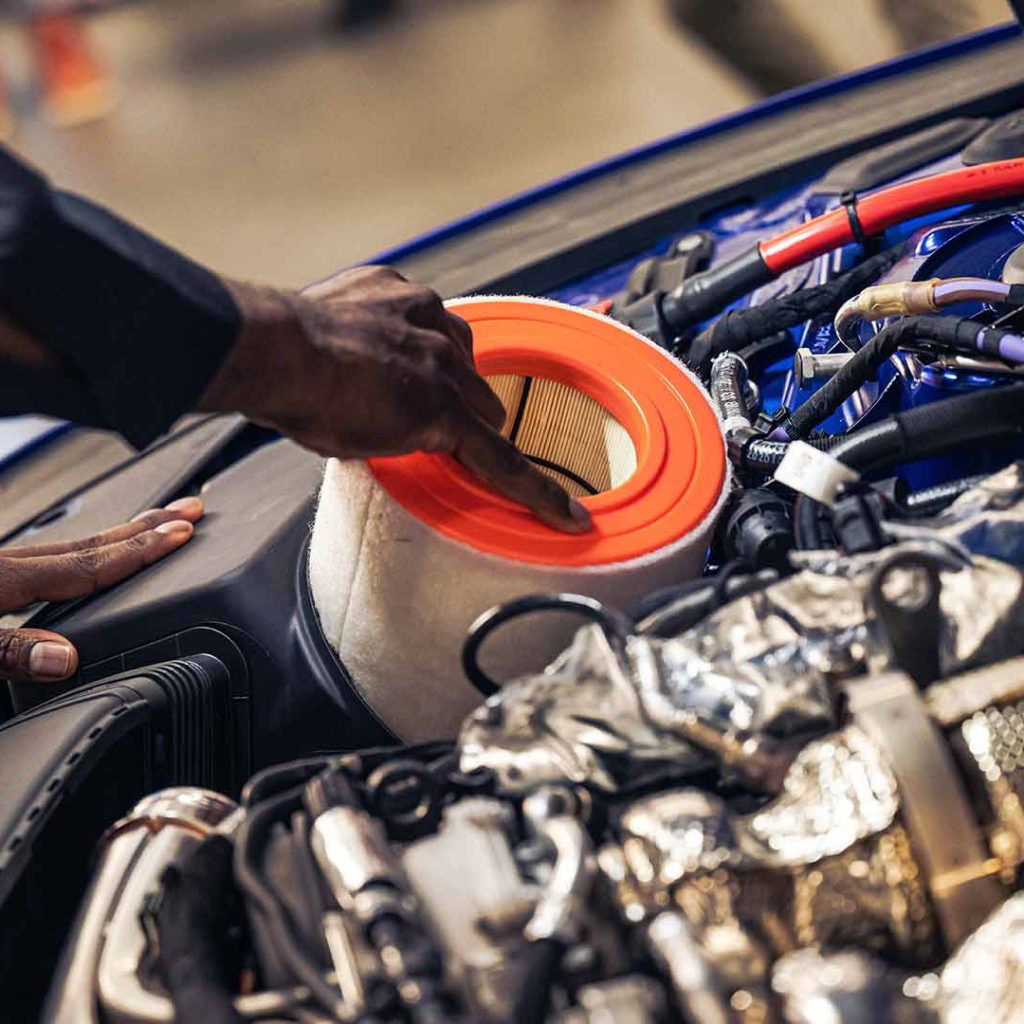 Audi service technician servicing a vehicle.