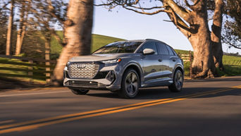 Front facing view of an Audi Q4 accelerating.