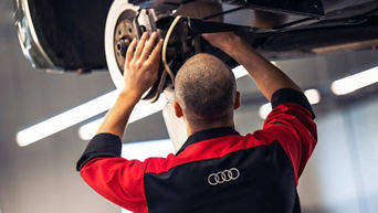 Service technician servicing tire.