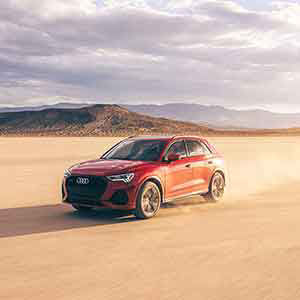 Side profile view of Audi Q3 driving. 