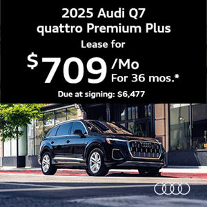 Audi Q7 parked by a building