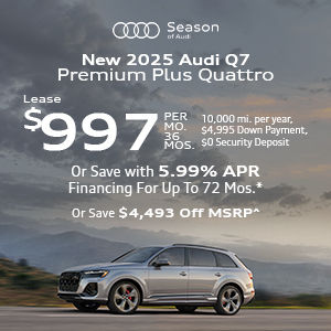 Side view of an Audi Q7 driving.