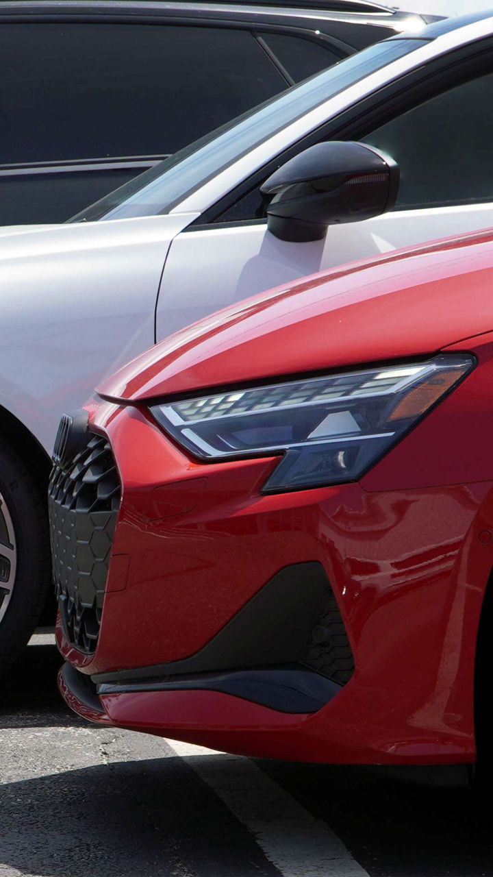 Left side profile view of 3 Audis parked