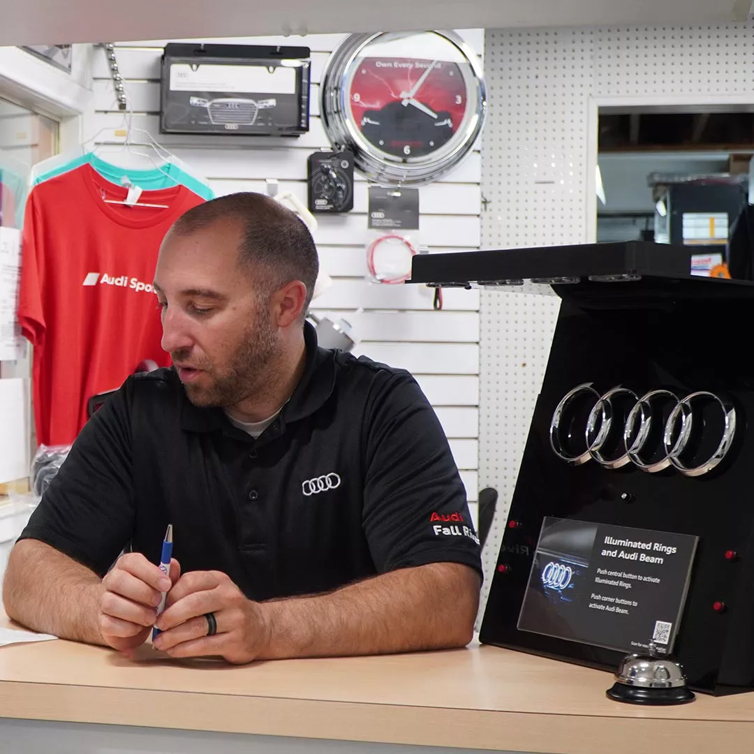 Three-quarter back view of an Audi A4 accelerating. 