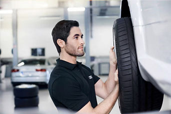 Service technician servicing tire