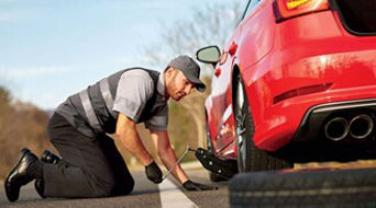 Service technician servicing vehicle.