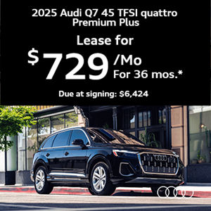 Audi Q7 parked near building and tree