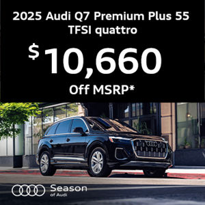 Audi Q7 parked near building and tree