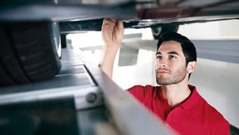 Technician serving vehicle brakes.