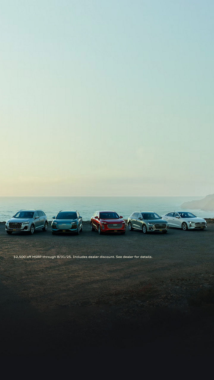 Lineup of new Audi vehicles at the coast