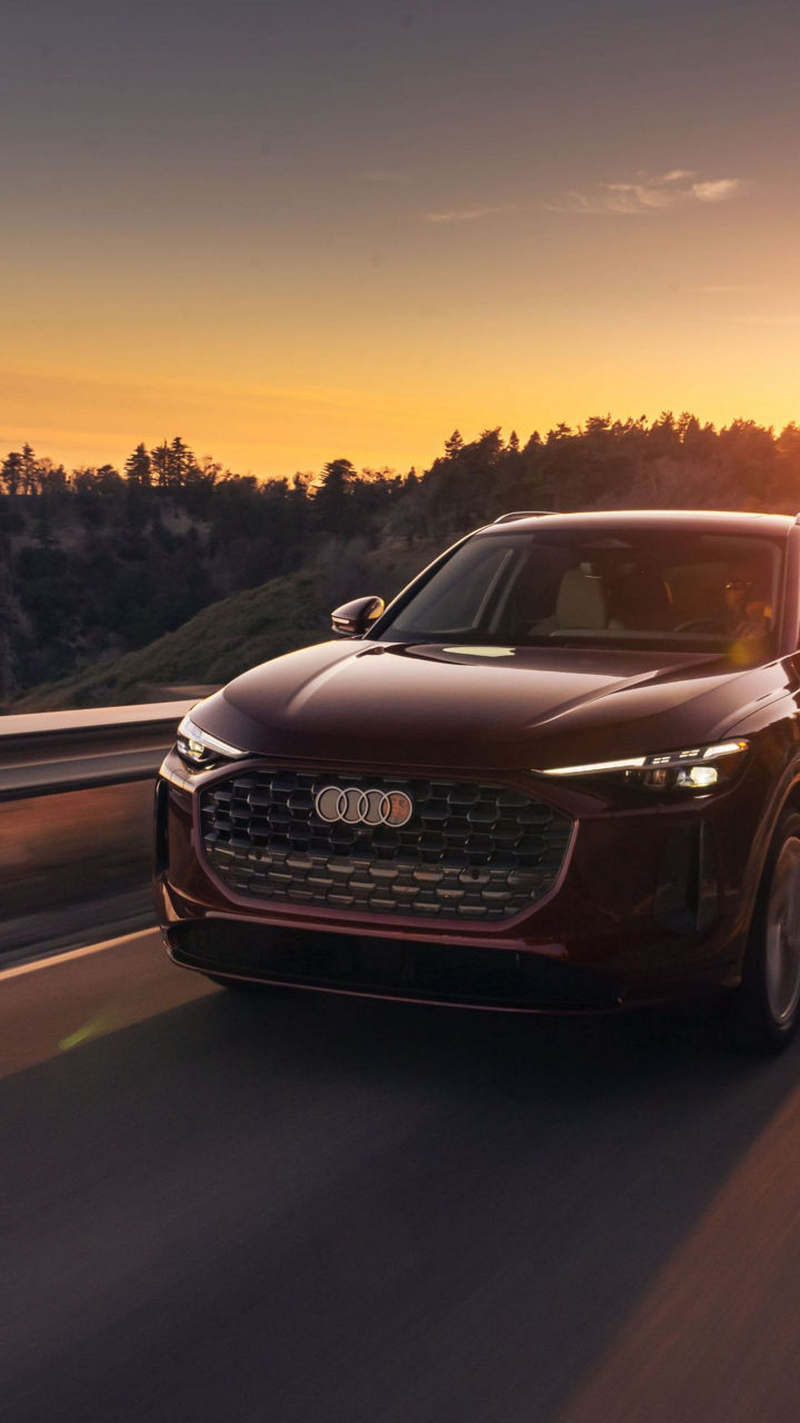 Three quarter profile view of an Audi Q5 accelerating. 