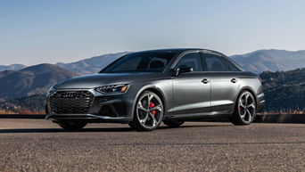 Three quarter profile view of an Audi A4 parked.