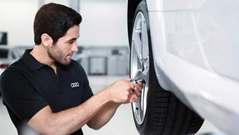 Audi Service specialist adjusting a wheel.