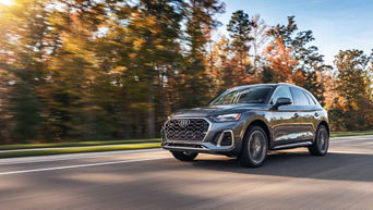 Three quarter profile view of an Audi Q5 accelerating.