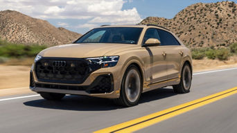 Three quarter profile view of an Audi Q8 accelerating.