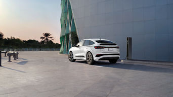 Three quarter profile rear view of an Audi Q4 e-tron parked.