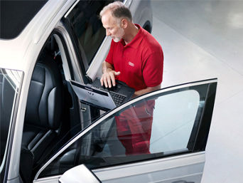 Service technician serving vehicle.