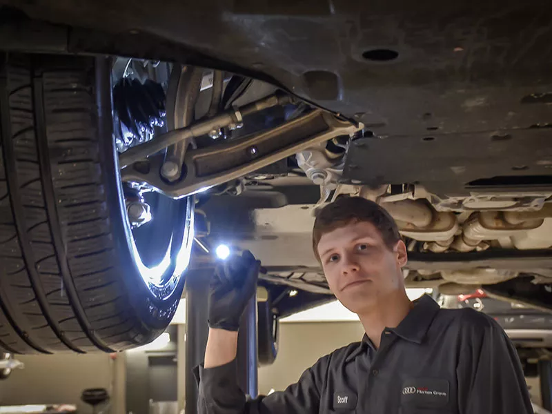 Service technician serving vehicle. 