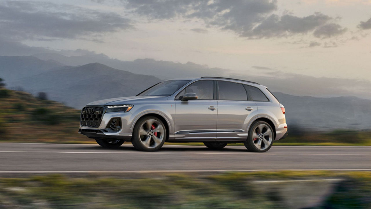 New 2025 Audi Q7 accelerating on a hilly terrain