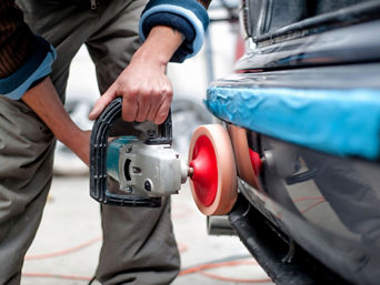 Service technician servicing vehicle.