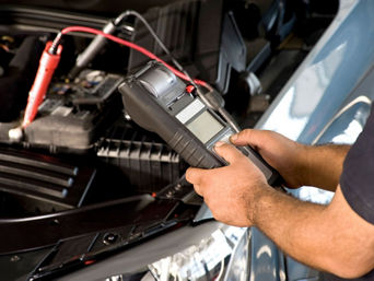 Service technician servicing vehicle.