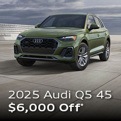 Three quarter profile view of an Audi Q5, parked.
