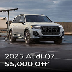 Three quarter profile view of an Audi Q7 parked.