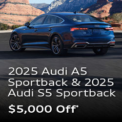 Three quarter profile view of an Audi A5 parked.