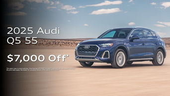 Three quarter profile view of an Audi Q5 accelerating.