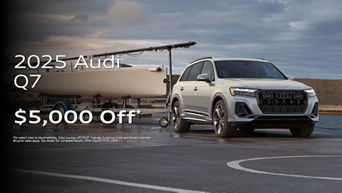 Three quarter profile view of an Audi Q7 parked.