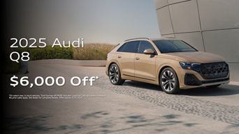 Three quarter profile view of an Audi Q8 parked.