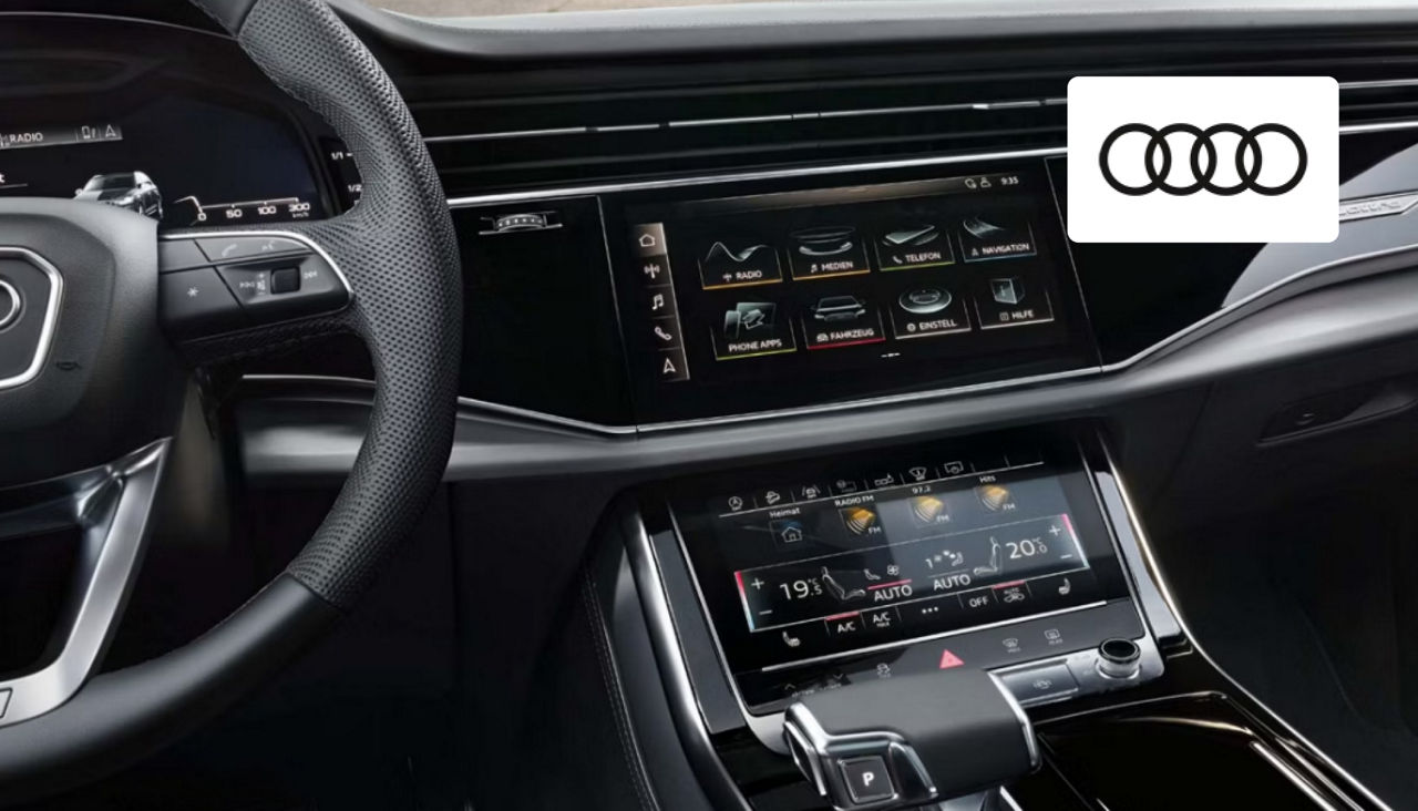 Driver enjoying the refined interior and advanced technology features of an Audi vehicle in Dayton, OH.