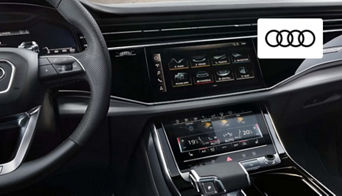 Driver enjoying the refined interior and advanced technology features of an Audi vehicle in Dayton, OH. 