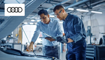  Audi technician performing an oil change on a luxury sedan at the Audi Dayton service center