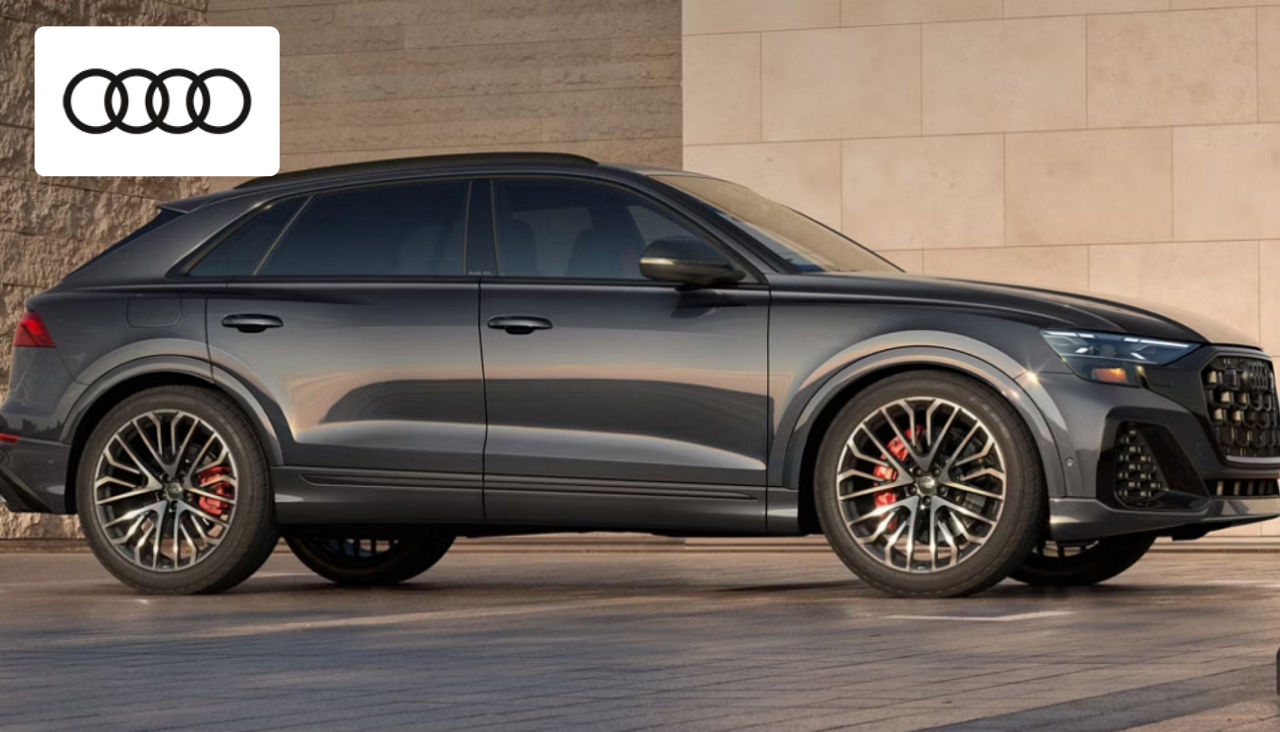 Audi SQ8 luxury SUV parked outside Audi Dayton, showcasing its sleek and athletic exterior design 