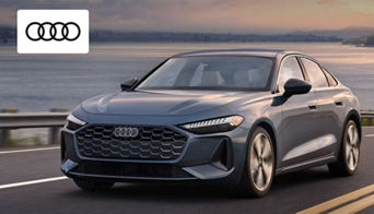 A sleek Audi coupe in motion on the open road, showcasing sporty performance and aerodynamic design.