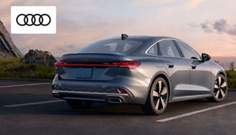 The interior of a luxury Audi coupe, highlighting high-tech features and upscale materials.