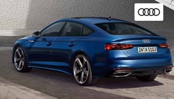 2025 Audi A5 Sportback parked in front of downtown Dayton skyline at sunset. 