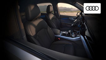 Interior view of the Audi Q7 featuring spacious three-row seating and MMI® touchscreen system 