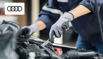  Audi service technician performing a professional oil change on a luxury Audi vehicle in Columbus, OH